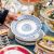 Hand of person holding a plate at an estate sale